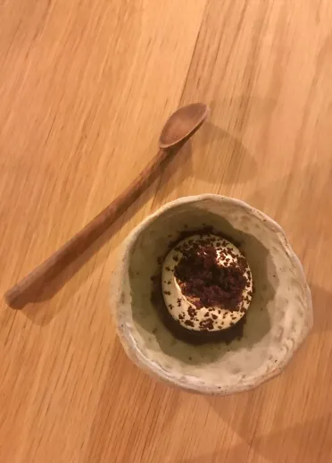 A bowl of food with a spoon.