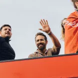 Ryan Reynolds waving from the Wrexham AFC bus