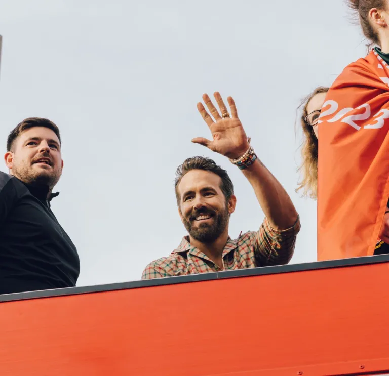 Ryan Reynolds waving from the Wrexham AFC bus