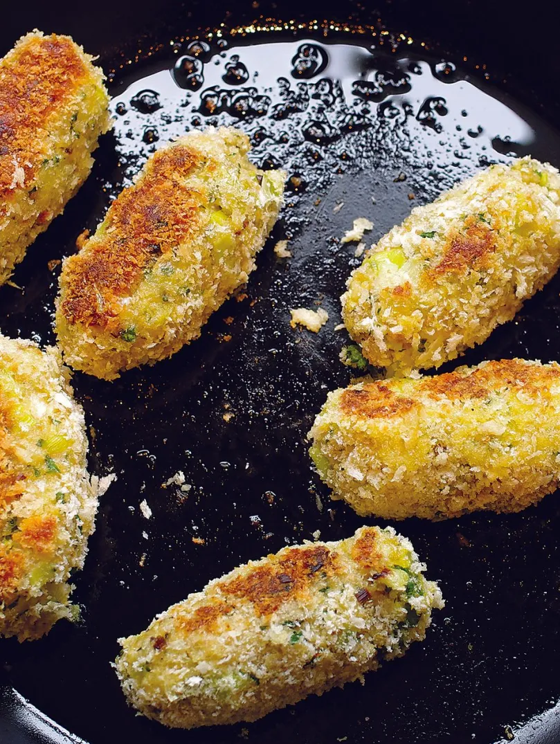 Glamorgan sausages frying in a pan
