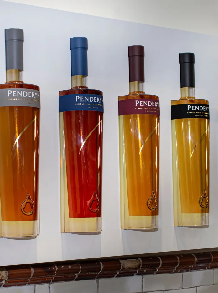 Bottles of whisky in a display case.