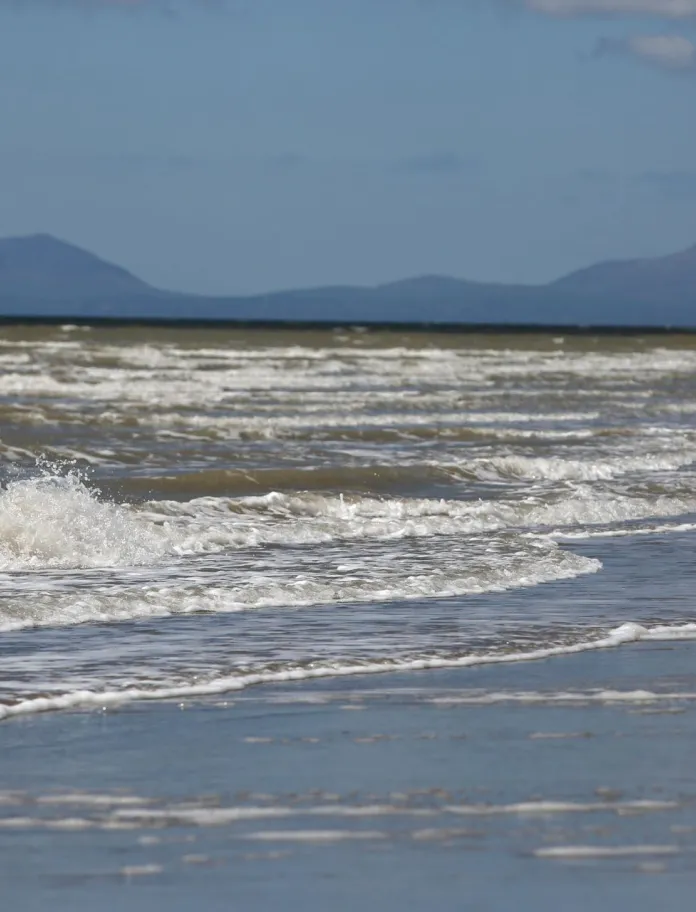 A picture of an on-shore wind farm in Wales featuring three wind turbines