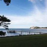 A view of the pier stretching out over blue water.