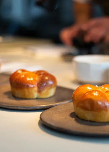 Bread rolls on plates ready to be served.