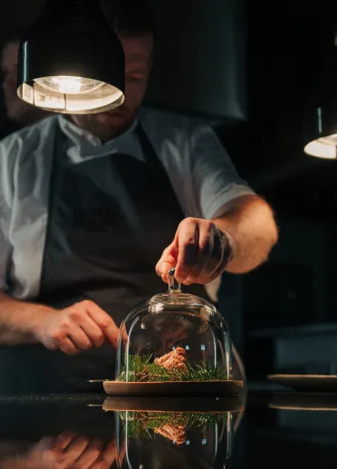 A chef preparing food in the kitchen.