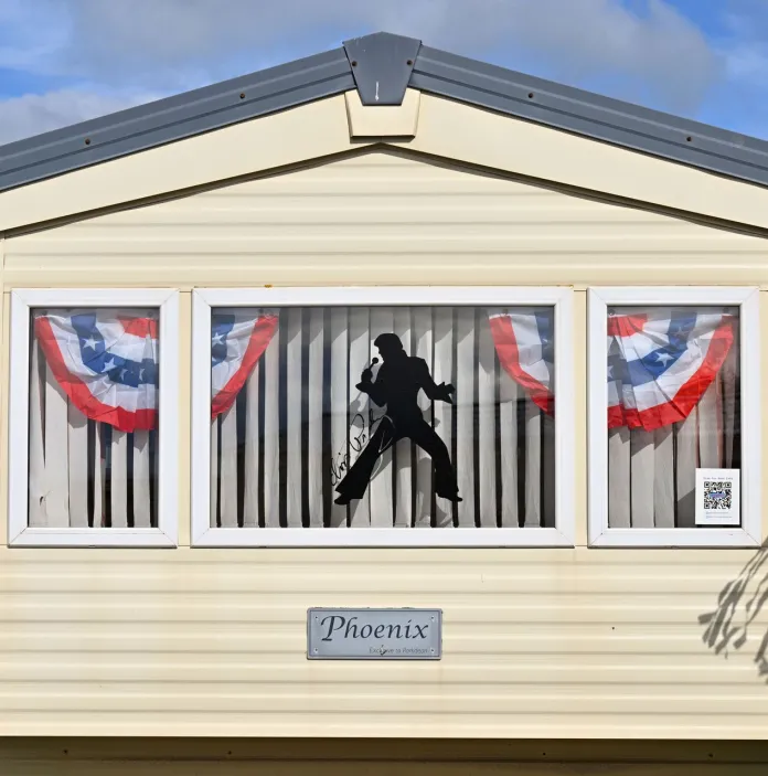 An Elvis sticker in the window of a caravan