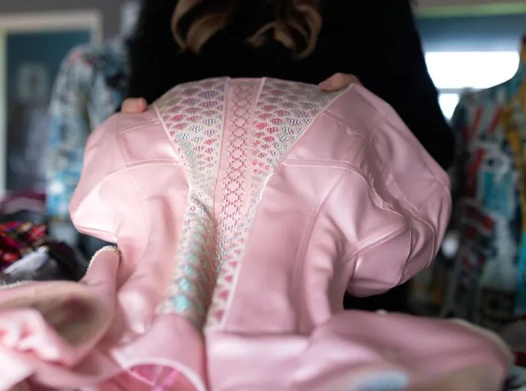 Fashion designer Jayne Pierson holding up a pink bodice