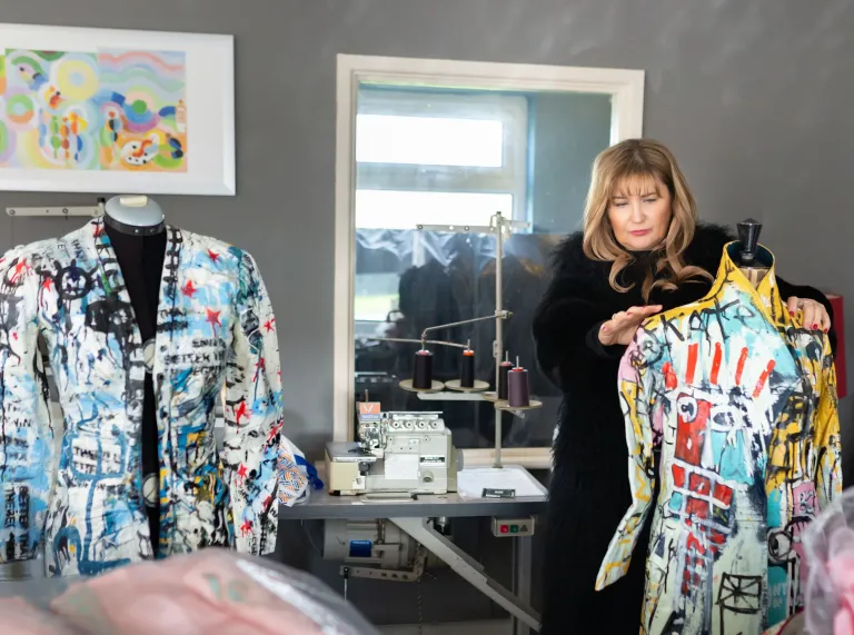 Fashion designer Jayne Pierson showing some of her bright bespoke designed dresses