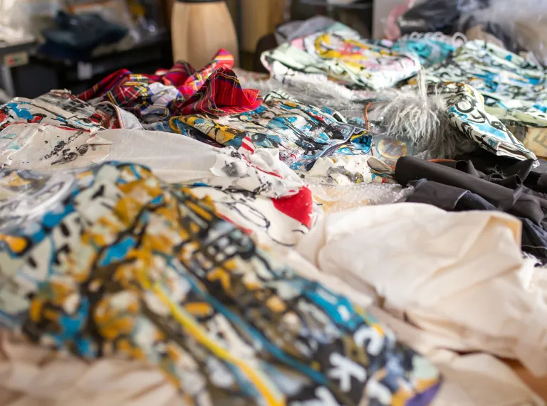 Colourful bespoke designed fabrics and garments in a high end fashion studio