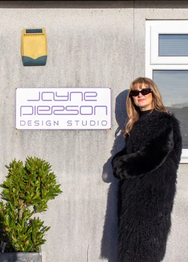 Jayne Pierson standing by the door of her fashion studio at Pembrey Airport