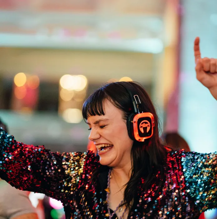A woman dancing at a silent disco.