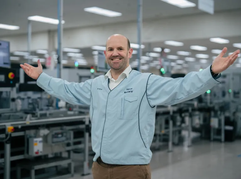 A man smiling with his arms in the air