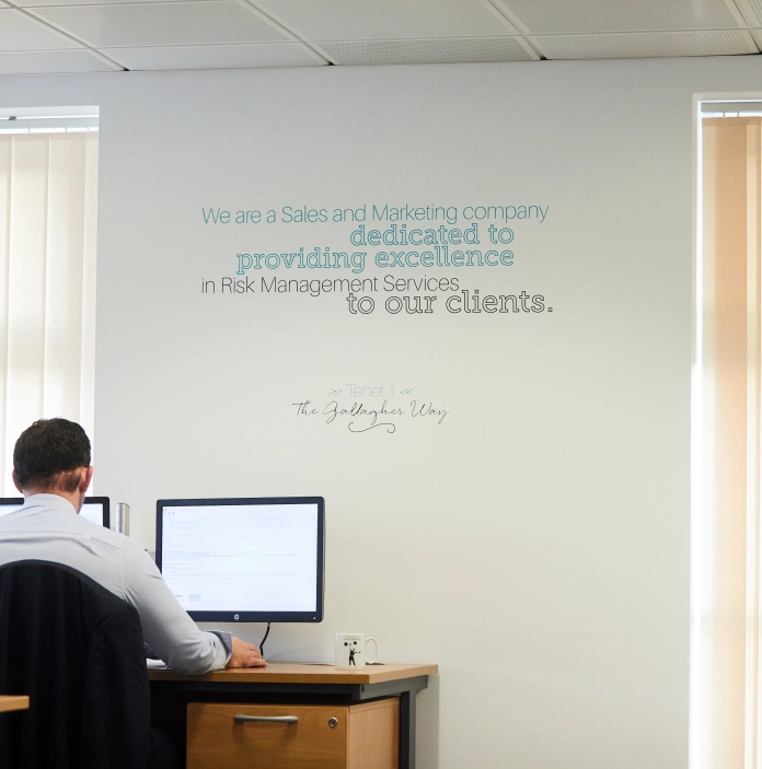 Man sat at desk, Arthur J. Gallagher Office Insurance Risk Management and Consulting