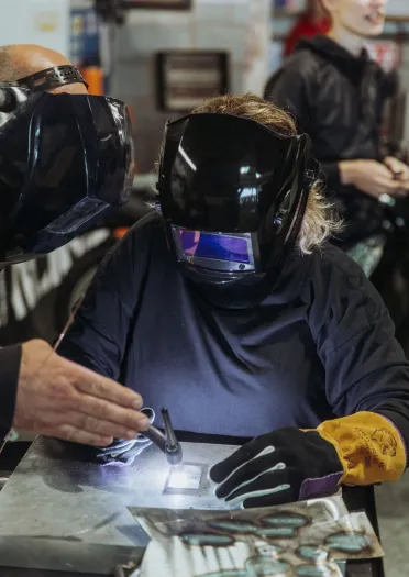 Two people welding