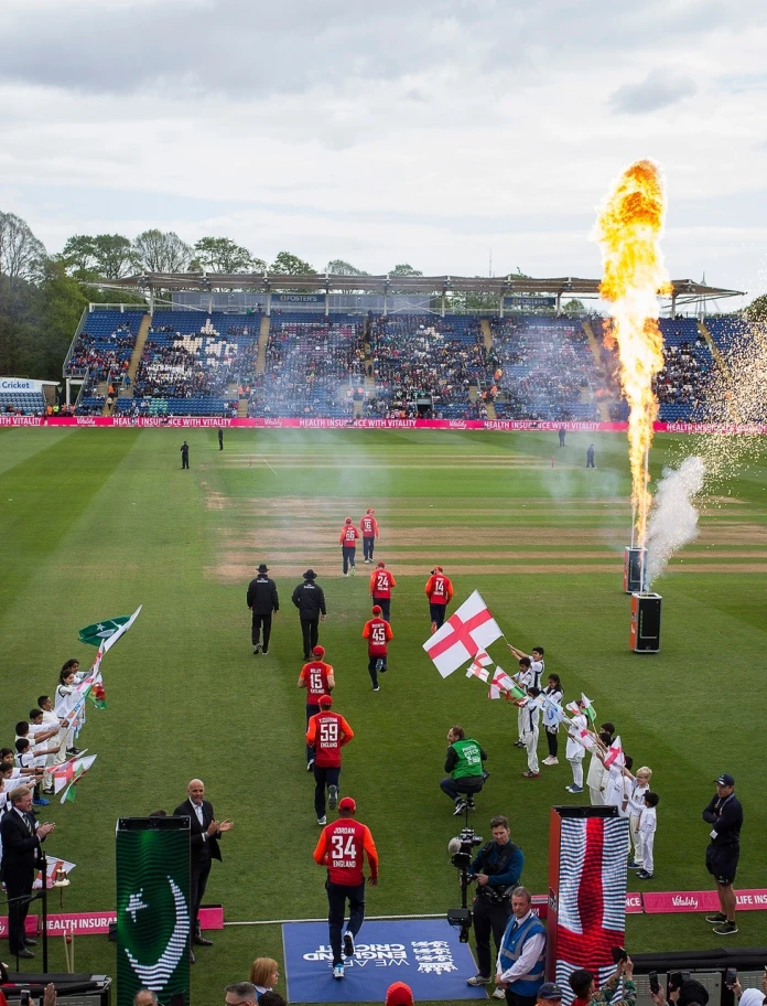 Cricketers walking onto the pitch 
