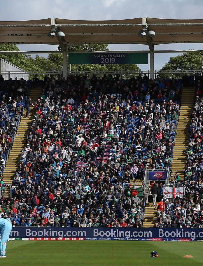 A crowd of people watching the cricket