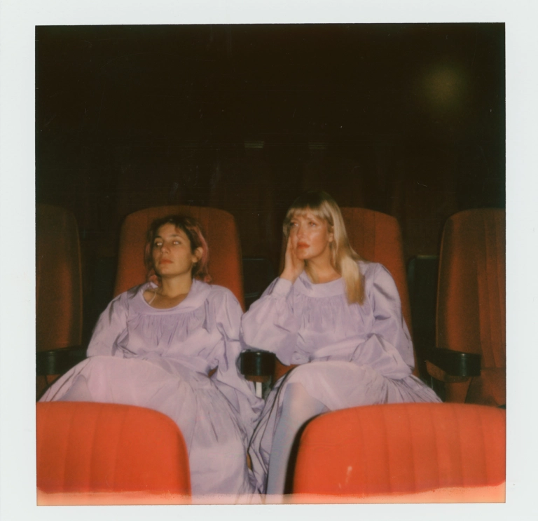 Two people sitting on chairs