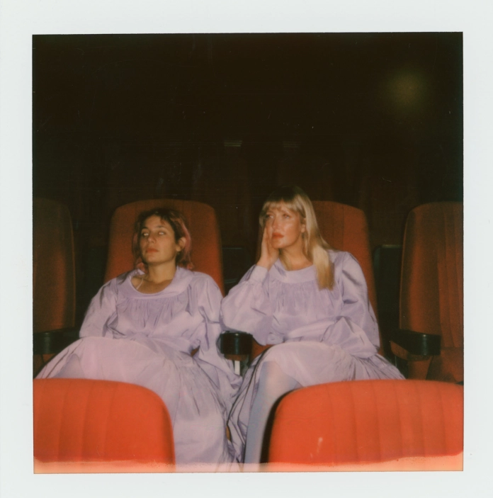 Two people sitting on chairs