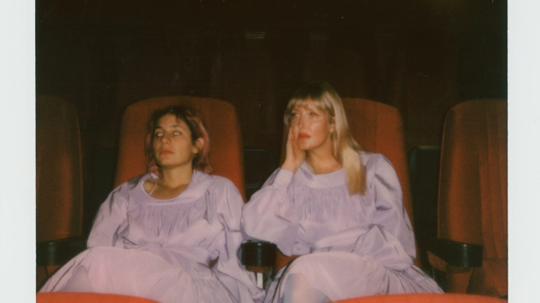 Two people sitting on chairs