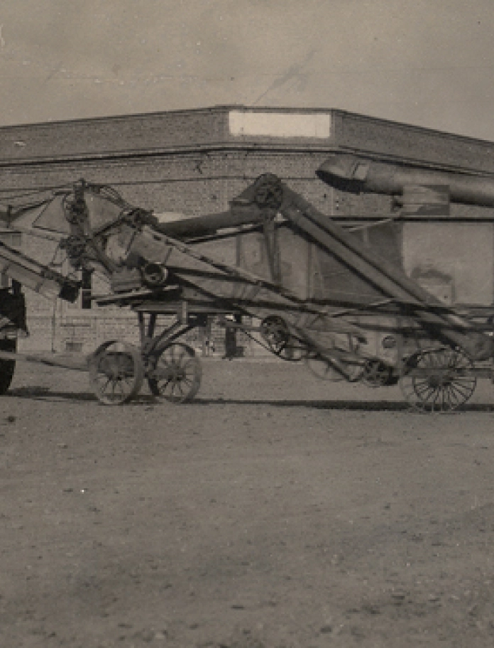 Tractor pulling farm machinery.