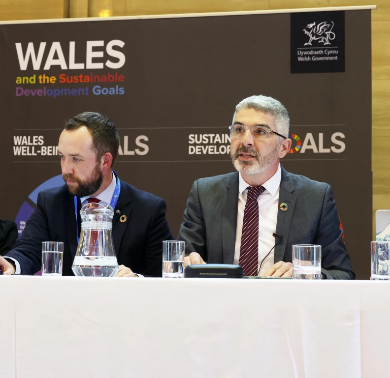 Four people sitting at a desk