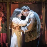 Two actors playing Romeo and Juliet acting on stage