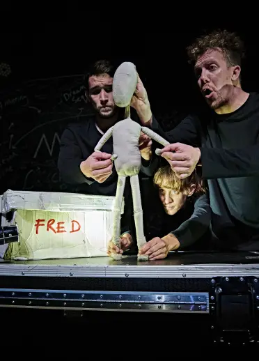Two people holding a model at Hijinx Theatre