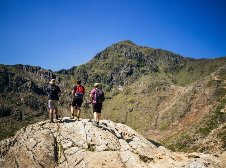 A group of people looking up at Snowdon.
