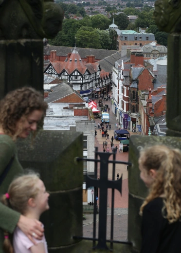 A family looking out from the top of the steeple.