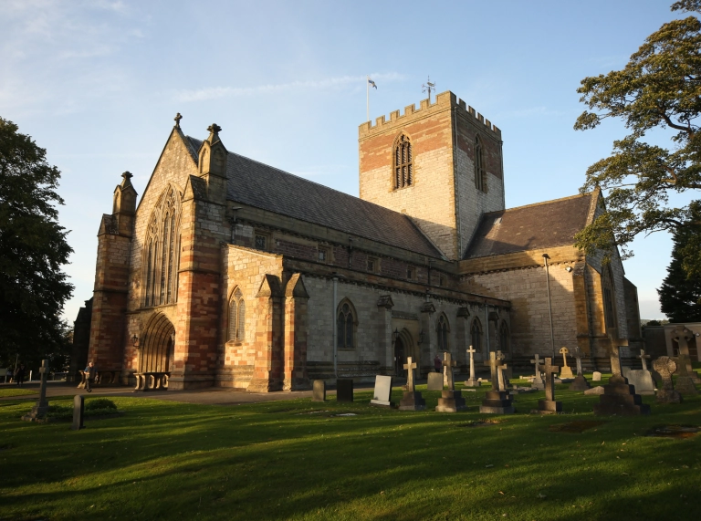 Exterior shot of cathedral with graves.