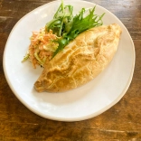 A Welsh oggy (pasty) served on a plate