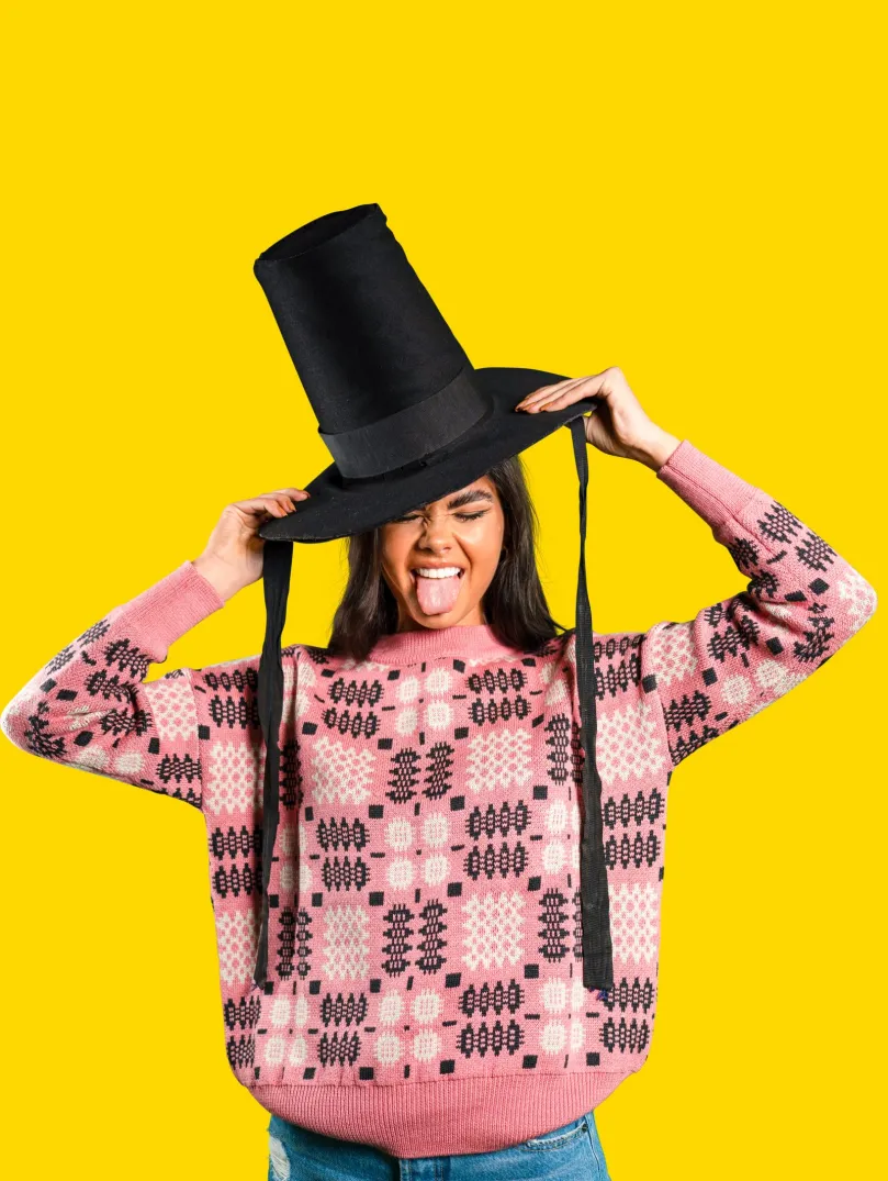 Woman wearing a Welsh hat and sticking her tongue out