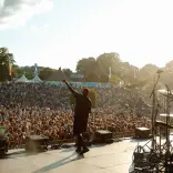 Man on stage in front of hundreds performing