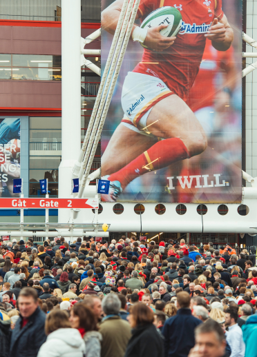 A large crowd of people outside a stadium where a Six Nations rugby match is about to be played