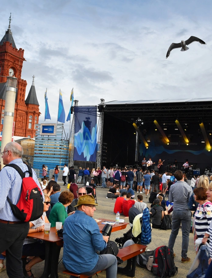 A band playing on a stage and a crowd watching them