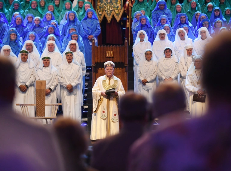 People standing on a stage in traditional costume