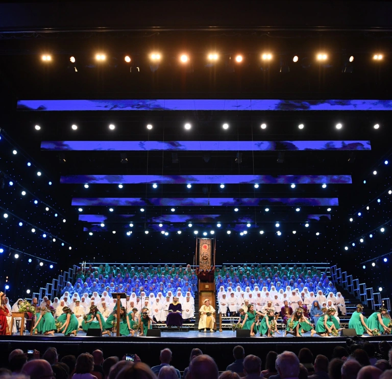 People dressed in costumes standing on stage.