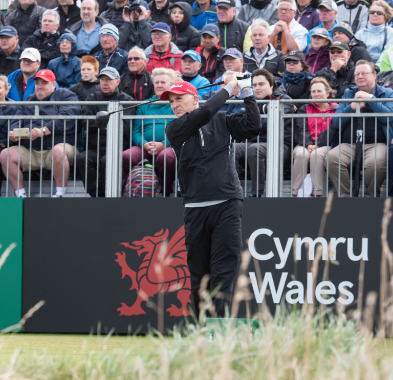 Phil Price playing golf at the Senior Open 2017 Royal Porthcawl Golf Club and crowd watching.