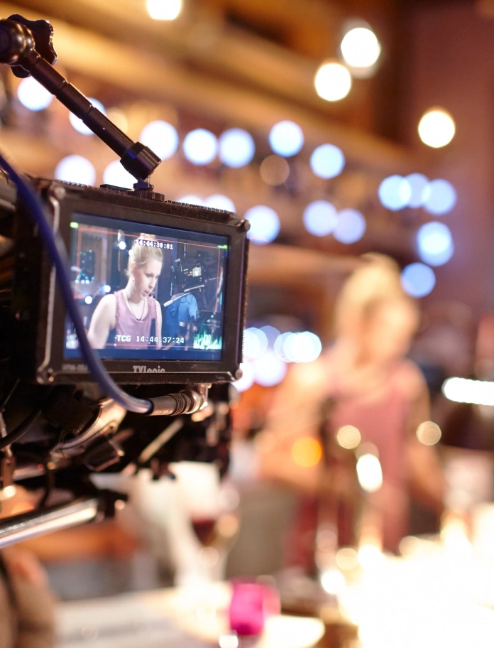 A camera filming actors.