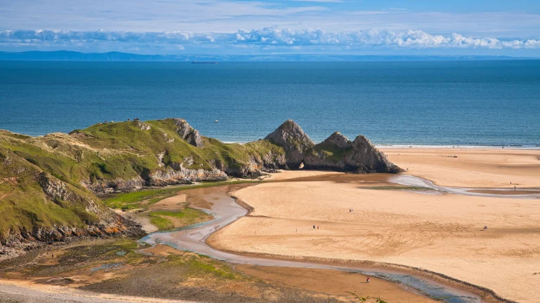 Three Cliffs Bay taken from dunes looking out at the Three cliffs and the sea