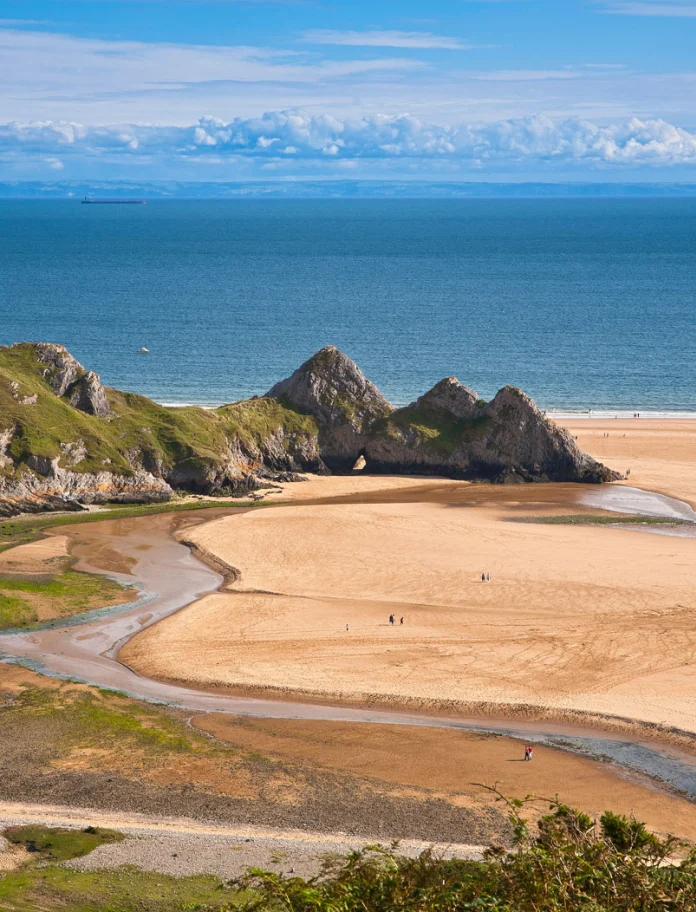 Three Cliffs Bay taken from dunes looking out at the Three cliffs and the sea