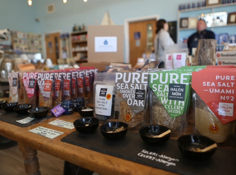Packets of salt on a counter.