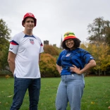 Two people standing and smiling at the camera.