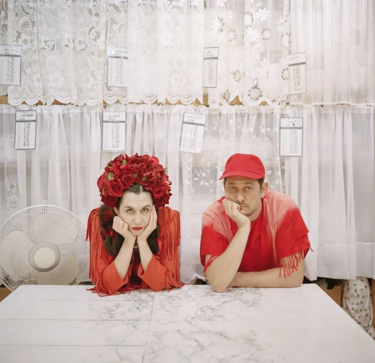 The two members of Rogue Jones sitting with their hands to their face.