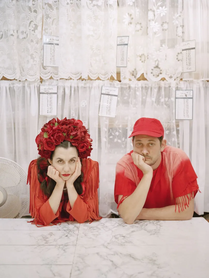 The two members of Rogue Jones sitting with their hands to their face.