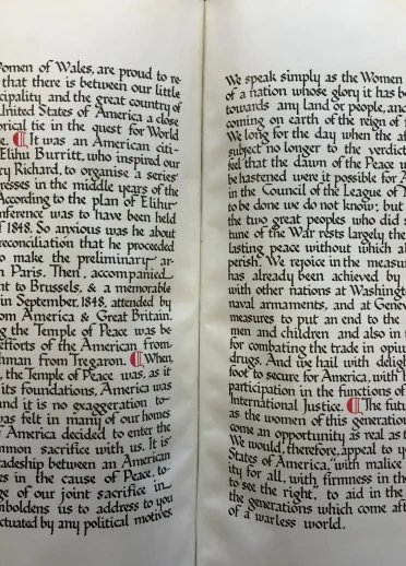 An open book showing the introductory text to a peace petition.