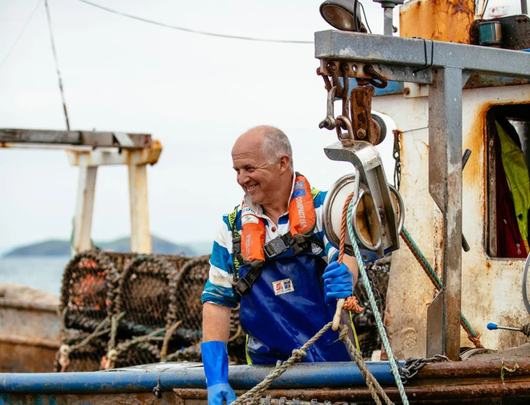 Catching shell fish off the side of the boat
