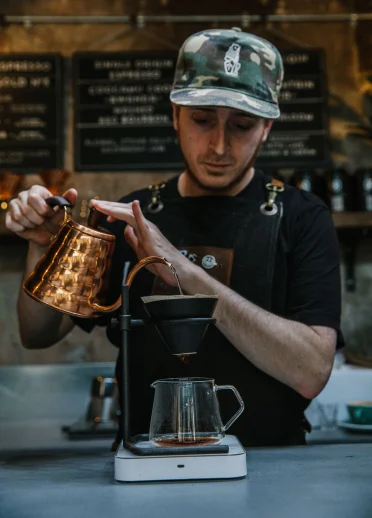 Filtering coffee behind counter