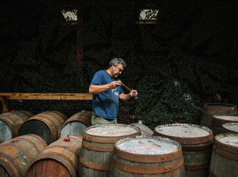  Andy Hallett tests cider from one of many barrels at Blaengawney Farm.