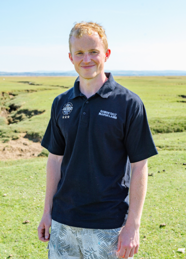 Farmer Will Pritchard with Gower countryside in the background.